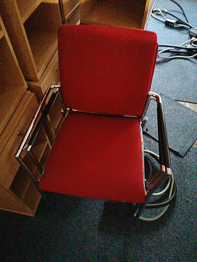 red and silver rolling chair