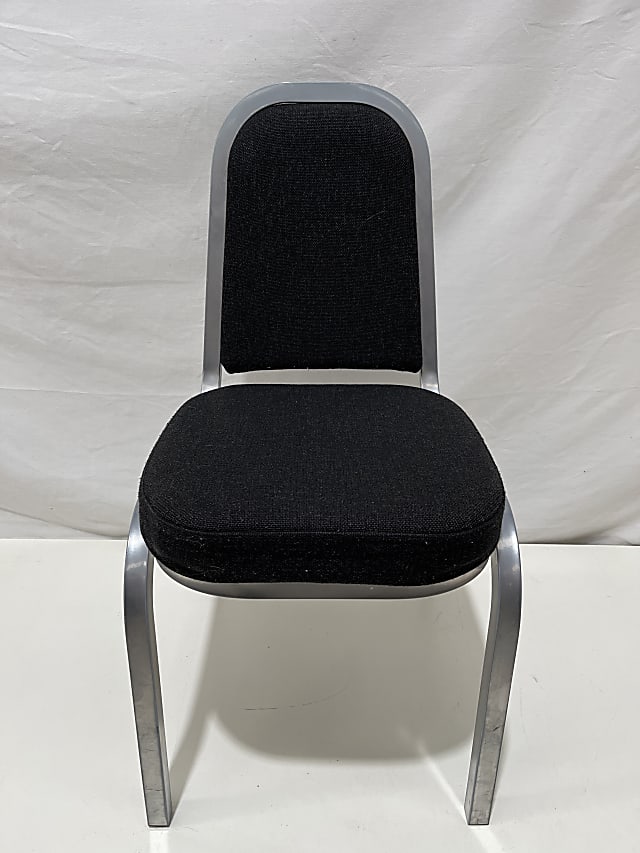 Black padded stacking stackable chair with silver metal frame