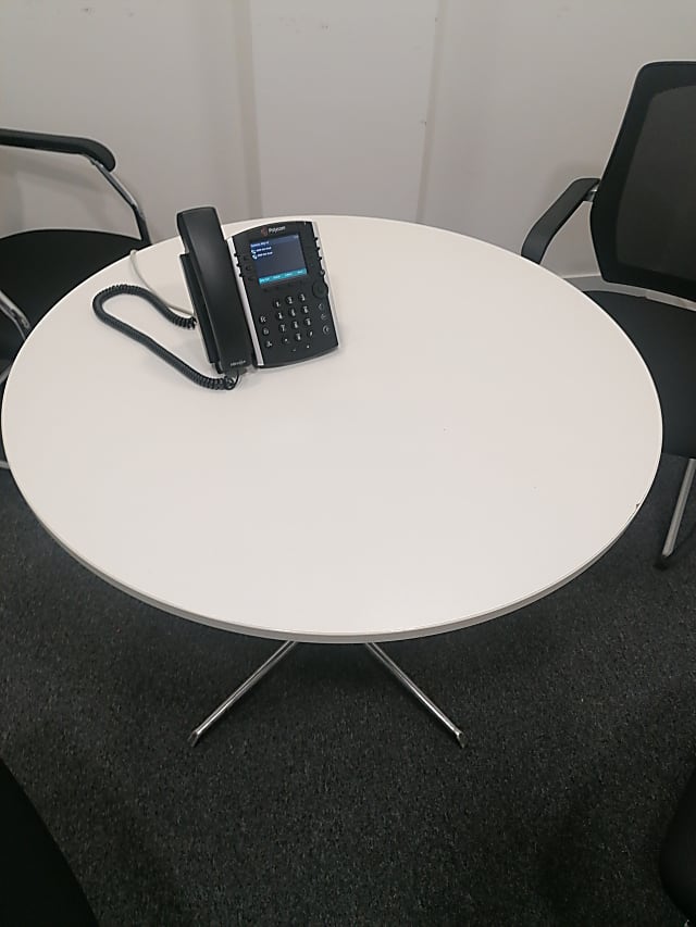 round white wooden table with black metal base