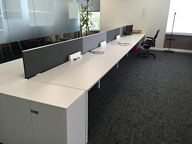 Bank of 8 white Steelcase desks back to back - 1600mm