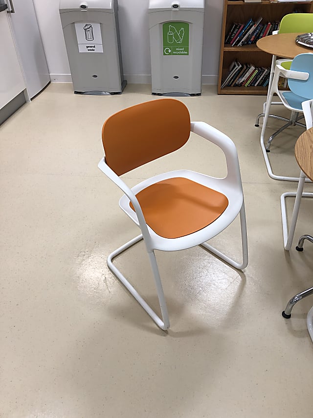 white metal framed brown wooden chair