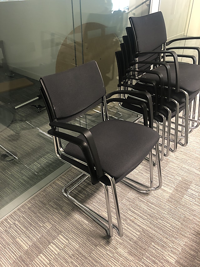 black metal framed gray padded chairs