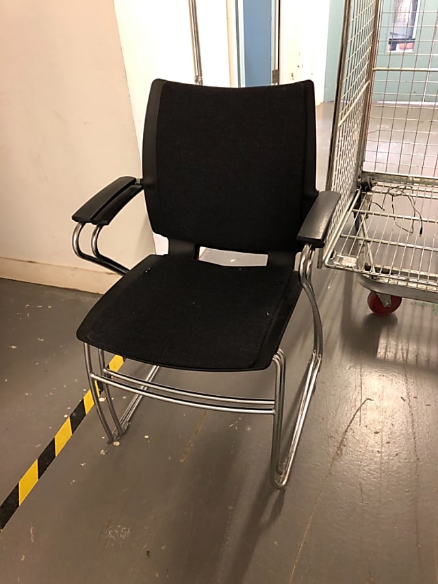 Black padded armchair with steel frame