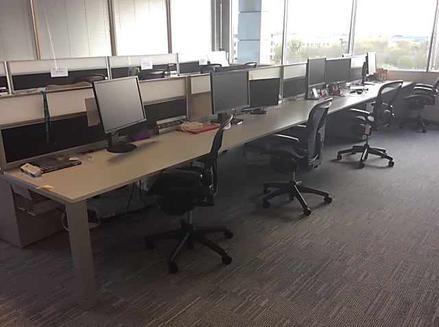 Bank of 8 grey Steelcase desks back to back