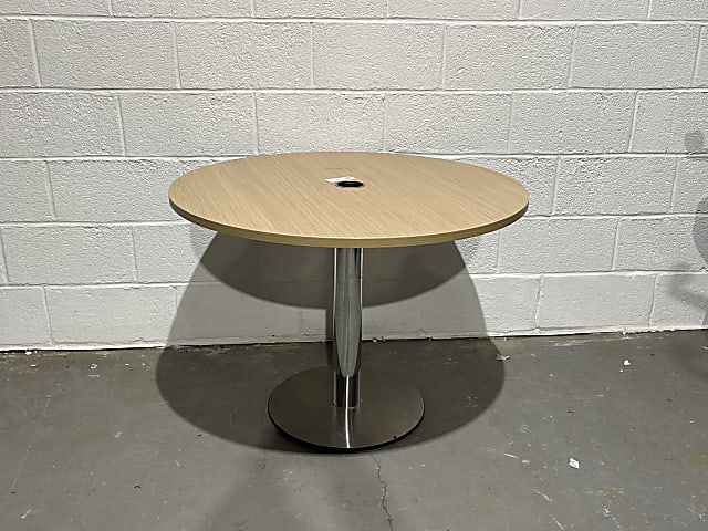 round brown wooden table with gray metal base