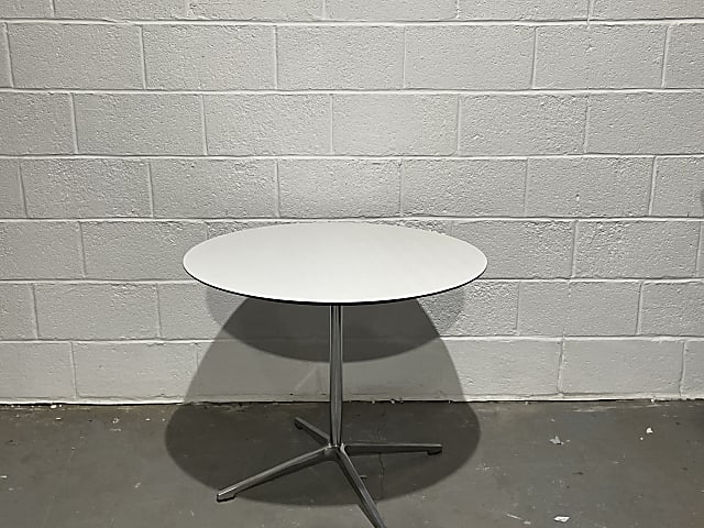 round white wooden table with metal base