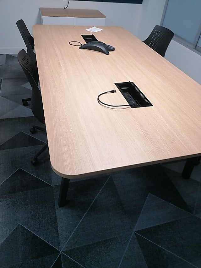 rectangular brown wooden table with black metal base