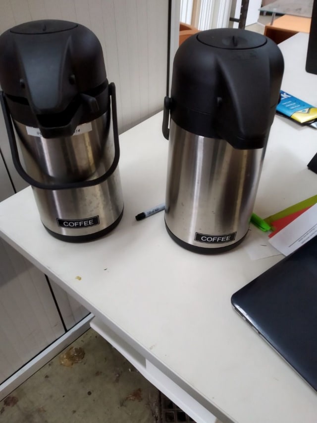 two black-and-grey hot drink dispensers