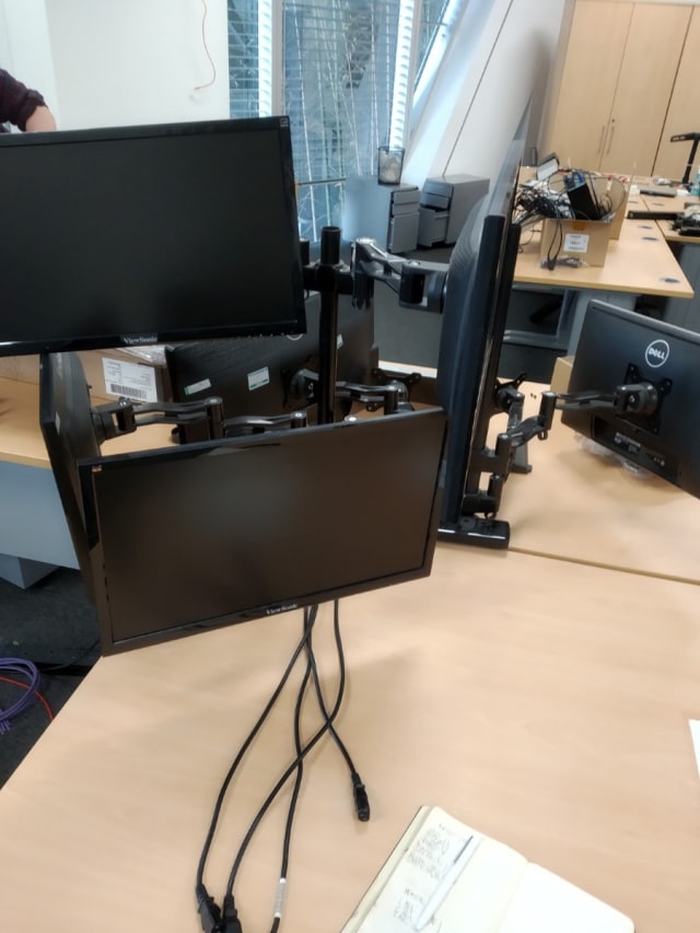 Three monitors on stand