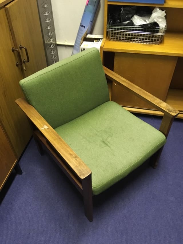 Green padded armchair