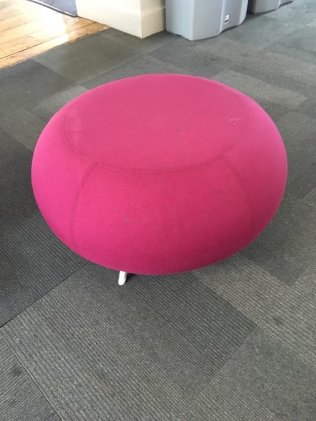 round pink fabric ottoman