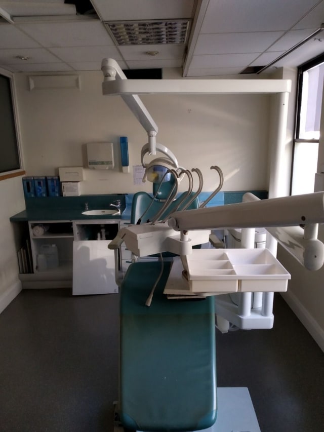 white and blue dentist chair