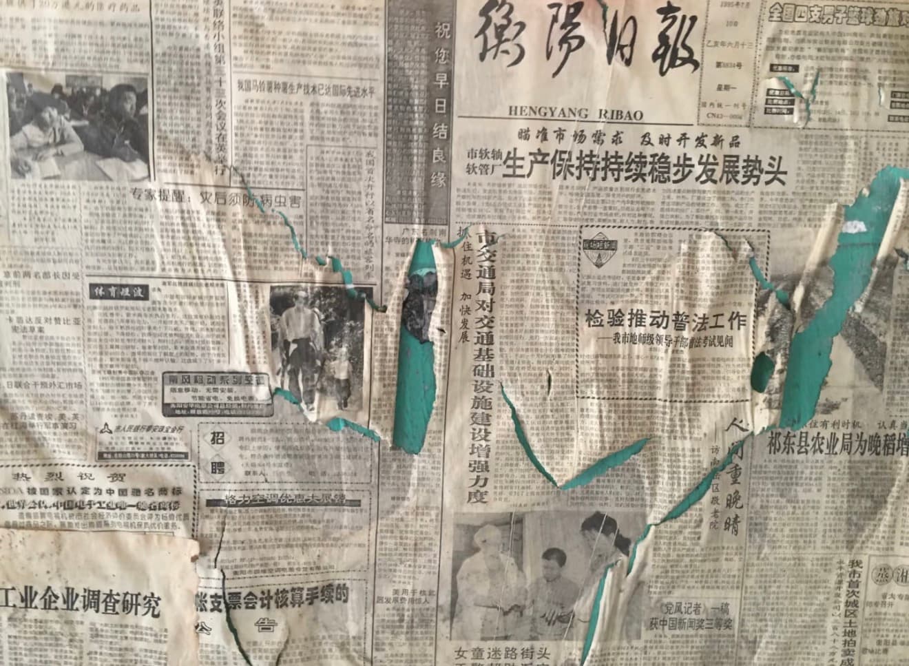 Peeling vintage newspapers on a wall