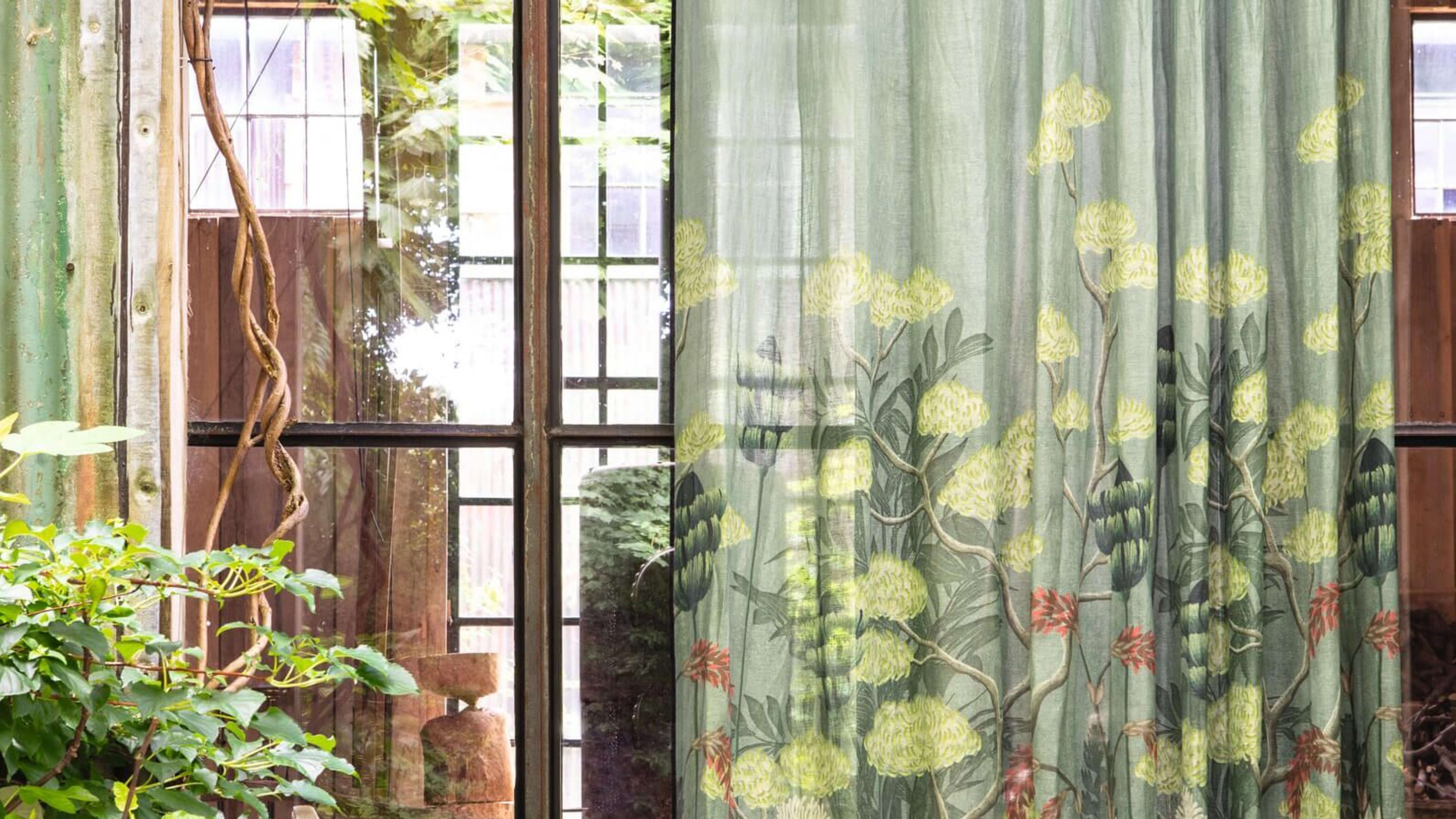 Aussenansicht von grünen Vorhängen an einem Fenster