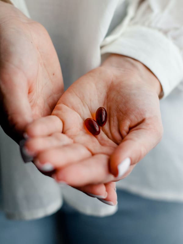 Hand Holding Two Pills