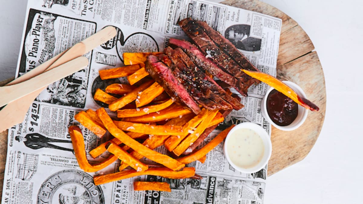 Steiks ar fritētiem saldajiem kartupeļiem un mērci