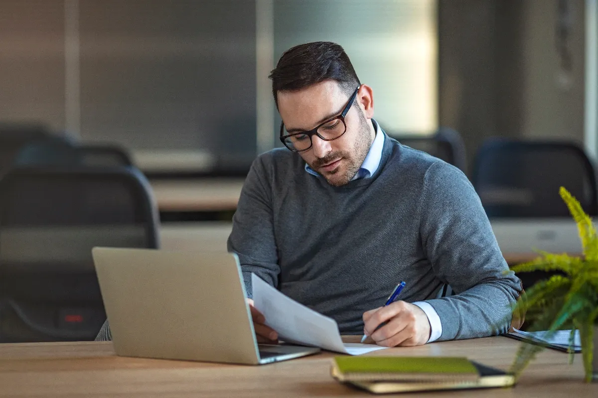Man writing an expense policy