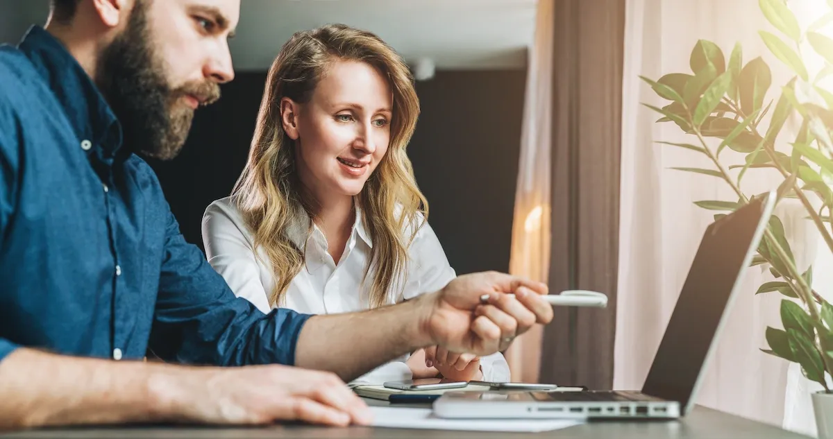 Man and woman looking at business intelligence tool.webp
