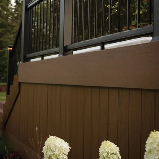 Composite deck and railing overlooking a landscaped yard
