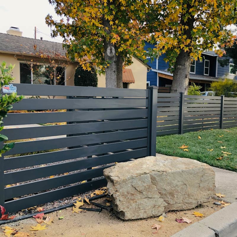 Aluminum fence and pedestrian gate on a sloped lot