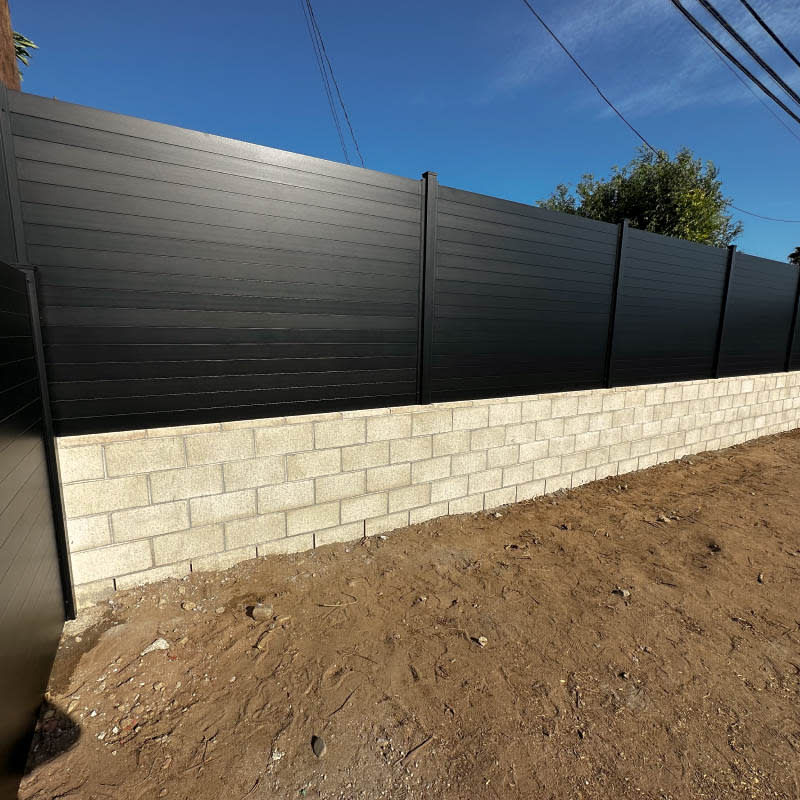 Aluminum fence panel between masonry columns
