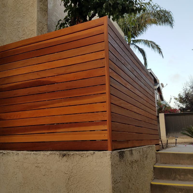 Tall redwood privacy fence with capped posts