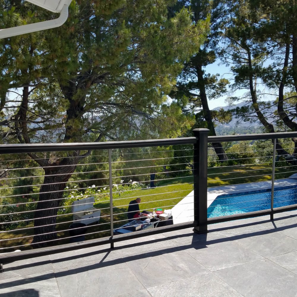 Stainless cable railing with a clean top rail on a deck edge