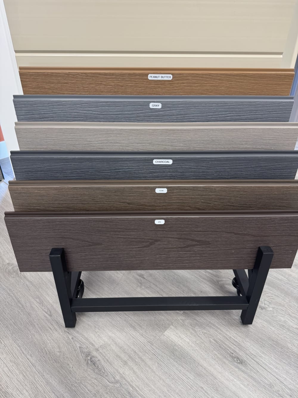 Composite fence colour rack with labelled panels in tan, grey and brown