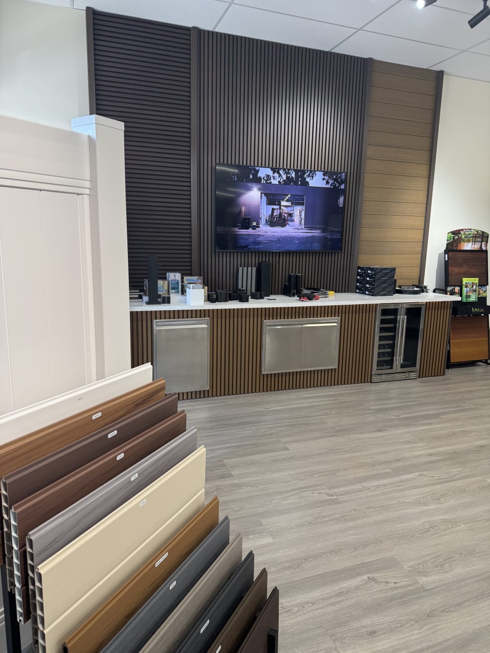 Wide view of the LA Fence Craft Rosemead showroom with display screen and sample racks