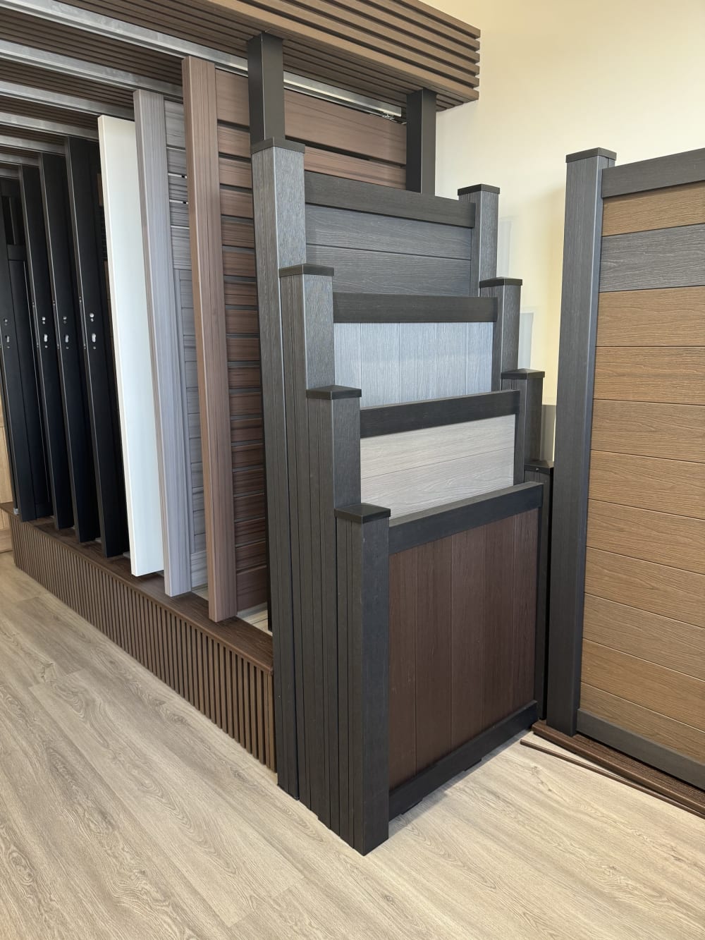 Sliding rack of composite and vinyl fence panels in the Rosemead showroom
