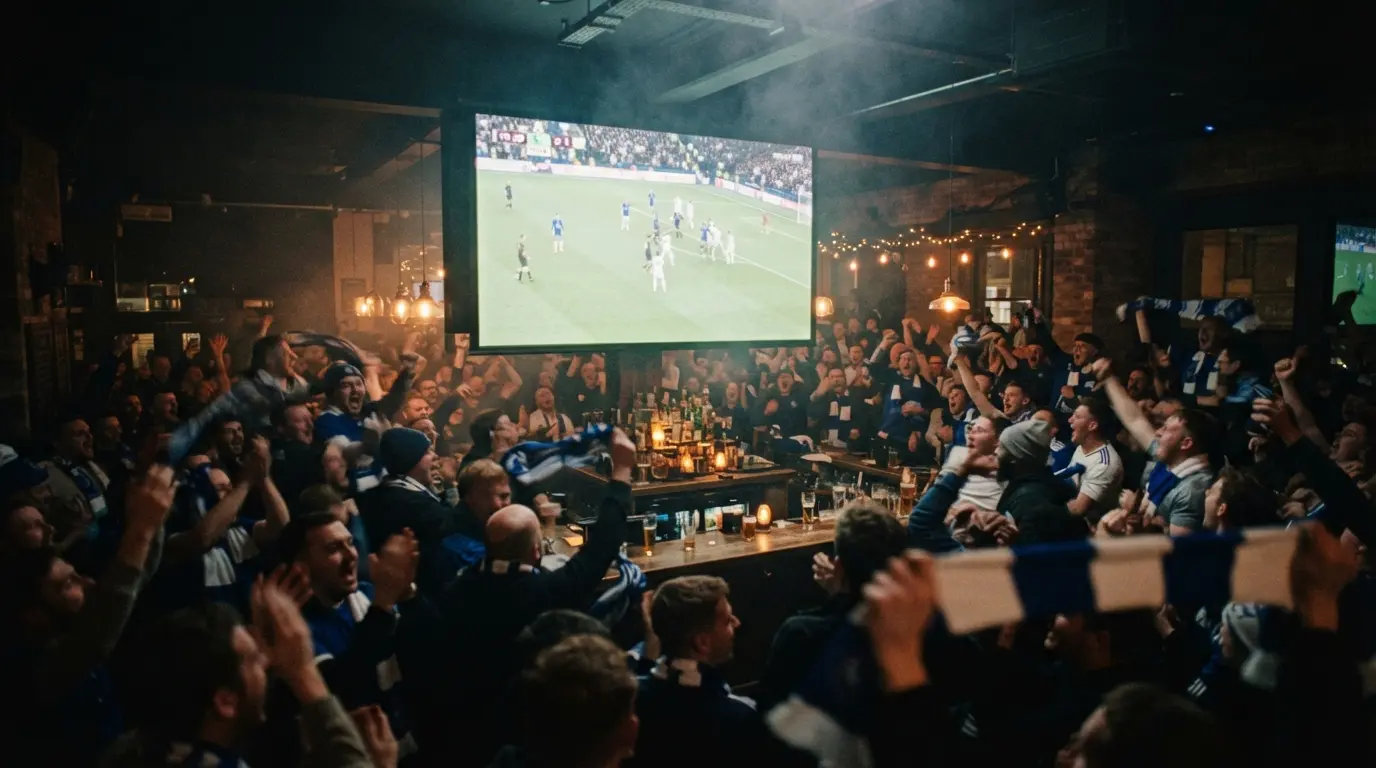 Crowd watching a football match on the big screen