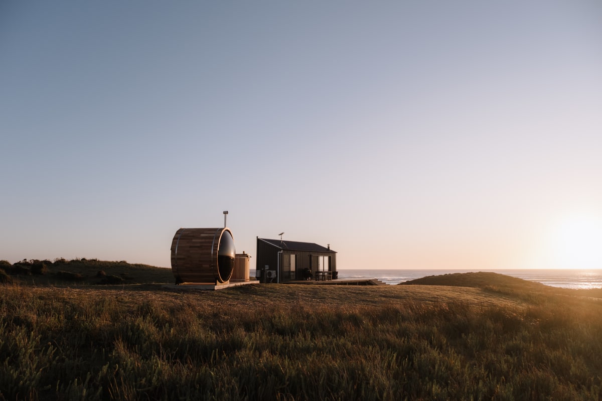 Red Rock Hut, sauna and Southern Ocean at sunset