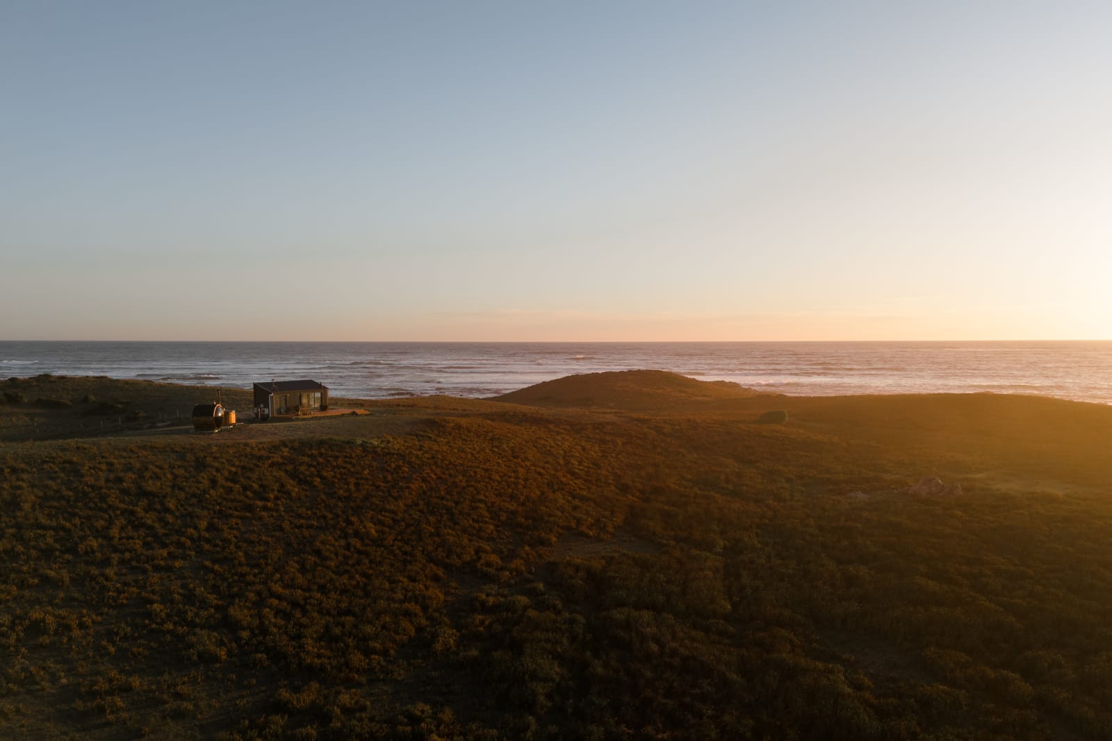 Red Rock Hut overlooking the Southern Ocean at sunset