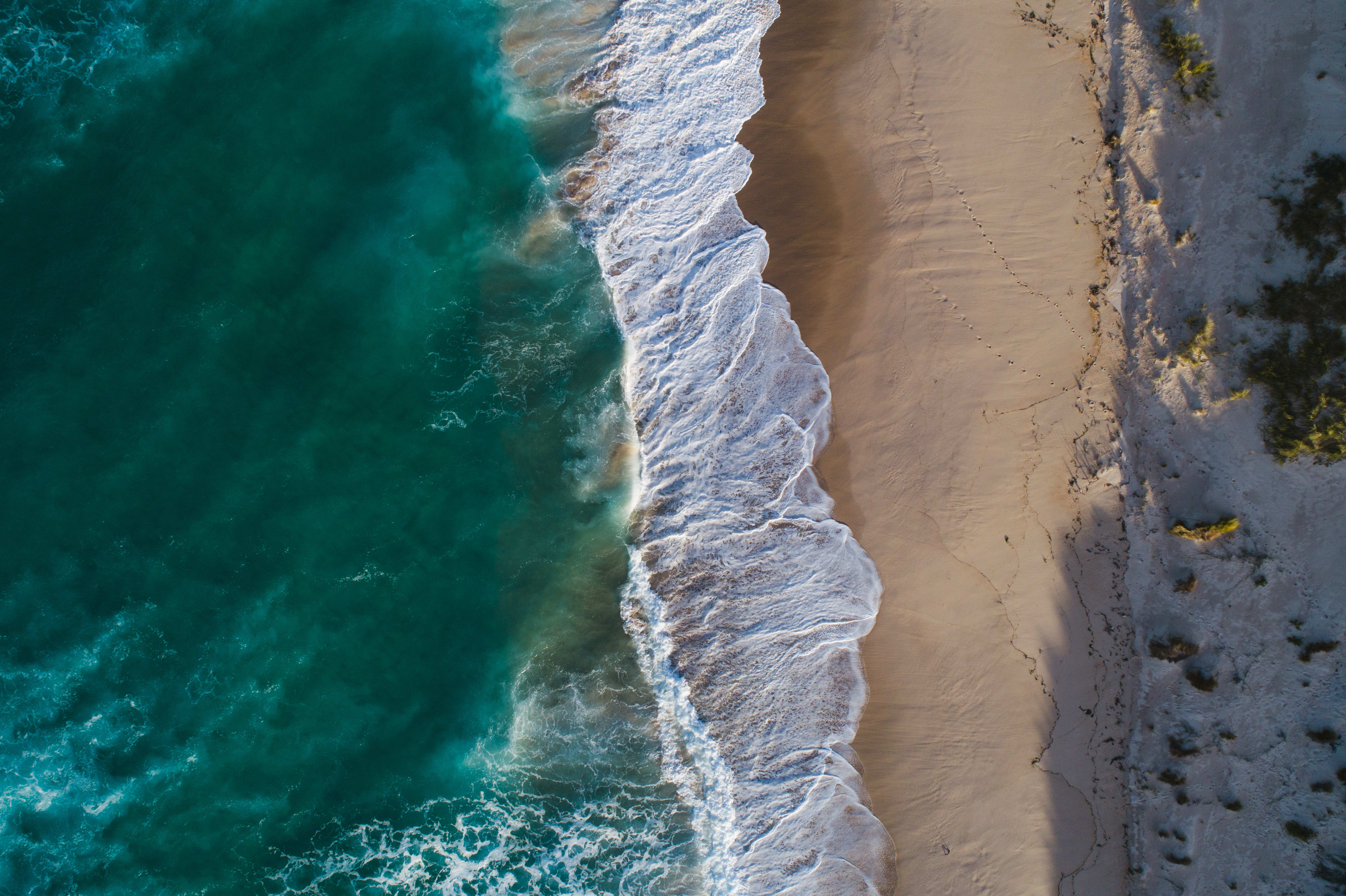 Waves meeting the King Island coastline from above
