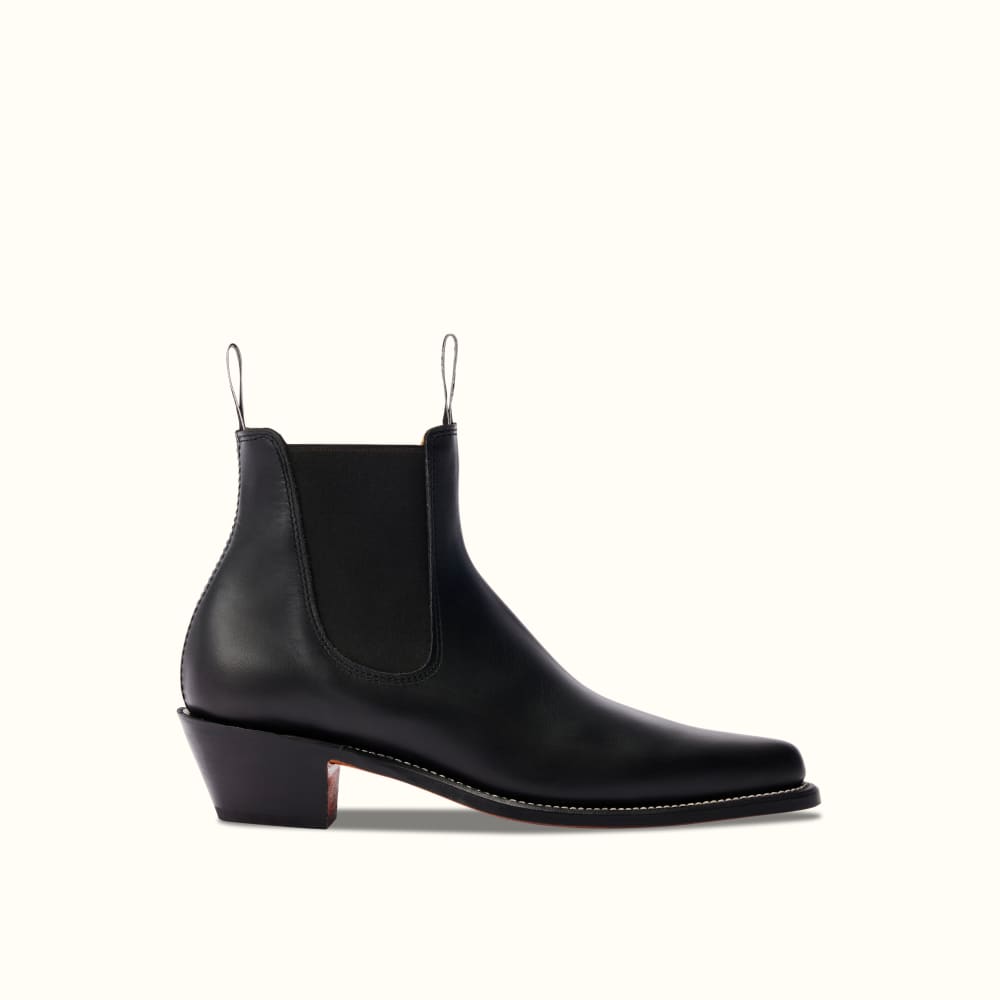 brings a new sensibility to statement footwear with these toe-capped black  over-the-knee boots
