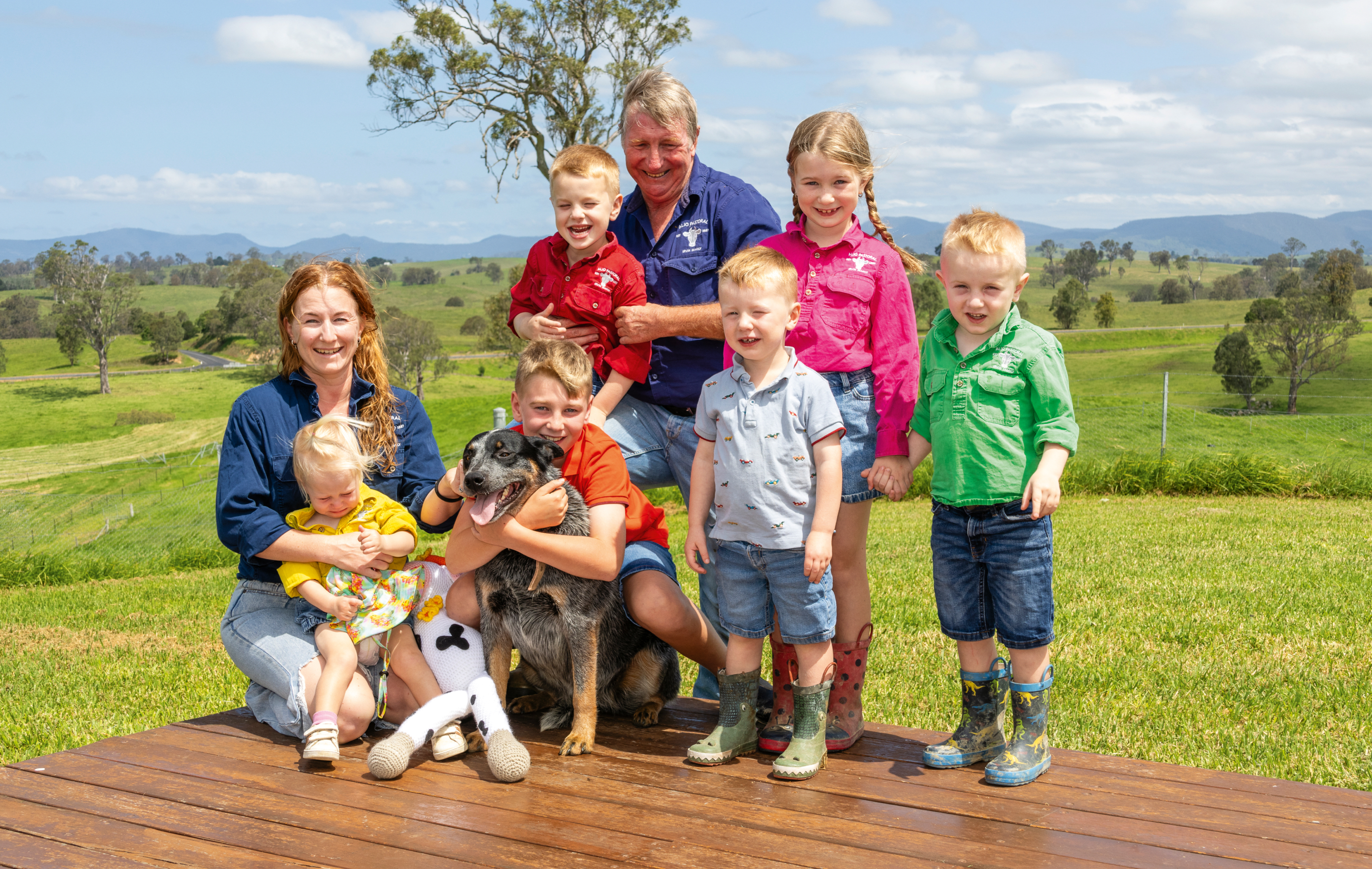 Barry with Abe  on his knee, daughter-in-law Zoe holding Zara, Lex with Ruby the blue heeler and Zac, Belle and Archie.
