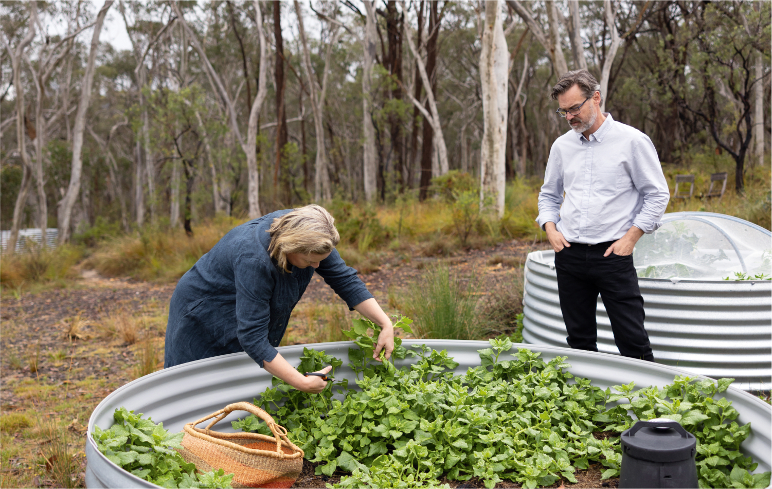  Kim Bell-Anderson dips into the raised gardens of the home she and husband Simon built in the Megalong Valley, NSW. 