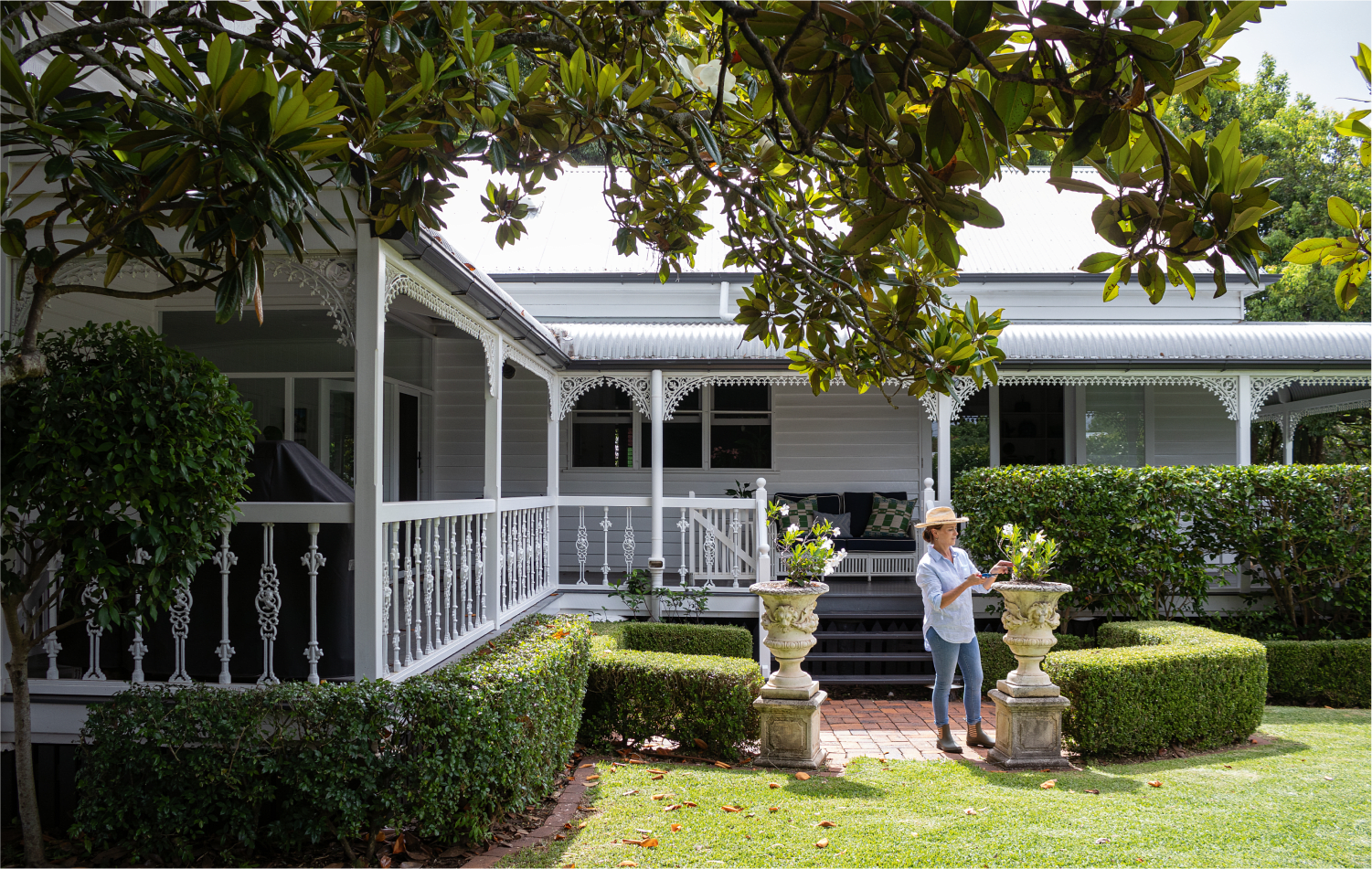  Toowoomba interior designer Angela Smith tends the garden of the classic Queenslander she and husband Bronte have carefully  renovated and extended. It is both a much-loved and practical family home, and a source of professional inspiration for her. 