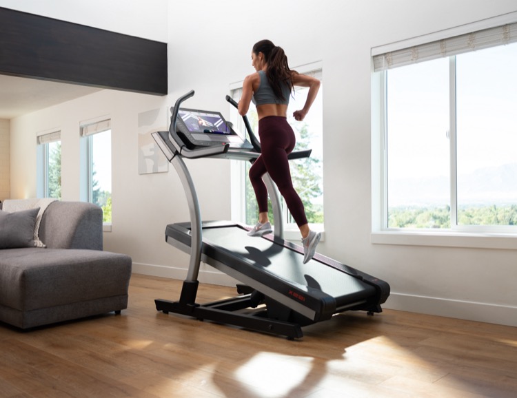 Person running on a treadmill in their home