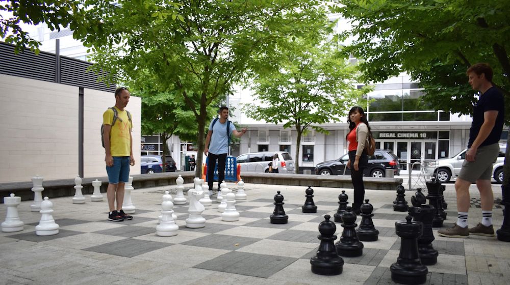 roboboogie team acting like pieces of a chess board while on a large chess board