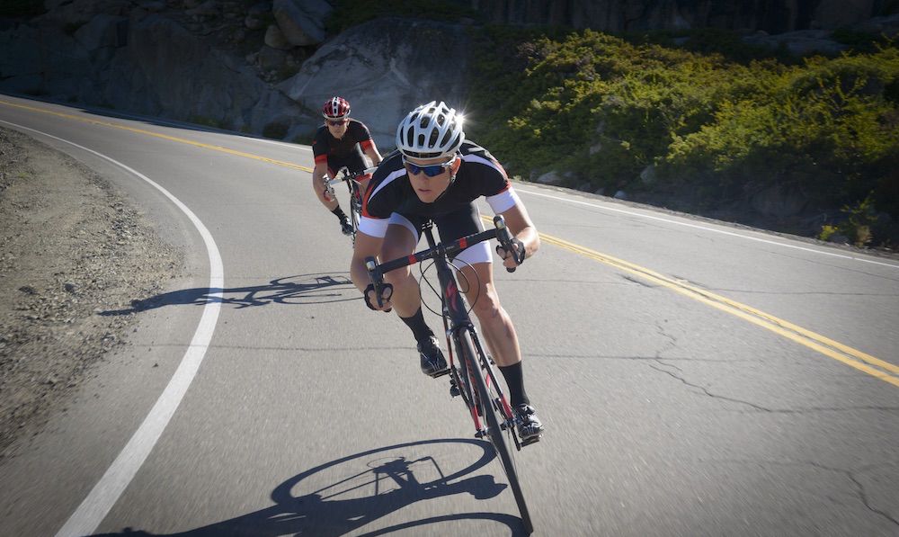 Two people riding Specialized road bikes