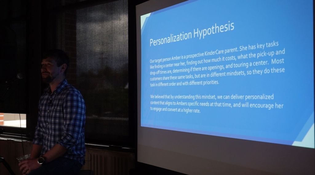 Ryan Summers, the Experience Optimization Lead at Connective DX in front of a presentation screen at Camp Optimization