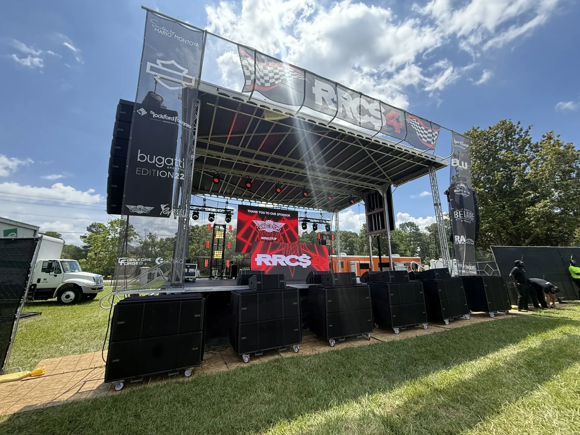 APEX 3224 concert stage with LED wall and speakers, daytime