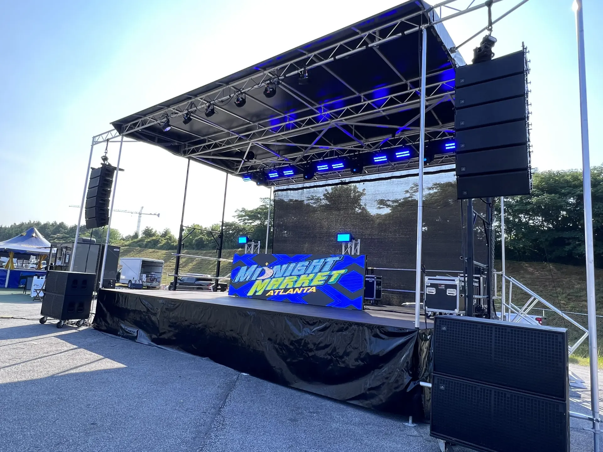 Midnight Market Atlanta stage with EuroStage ES2620, line array PA, ground subs, and LED screen