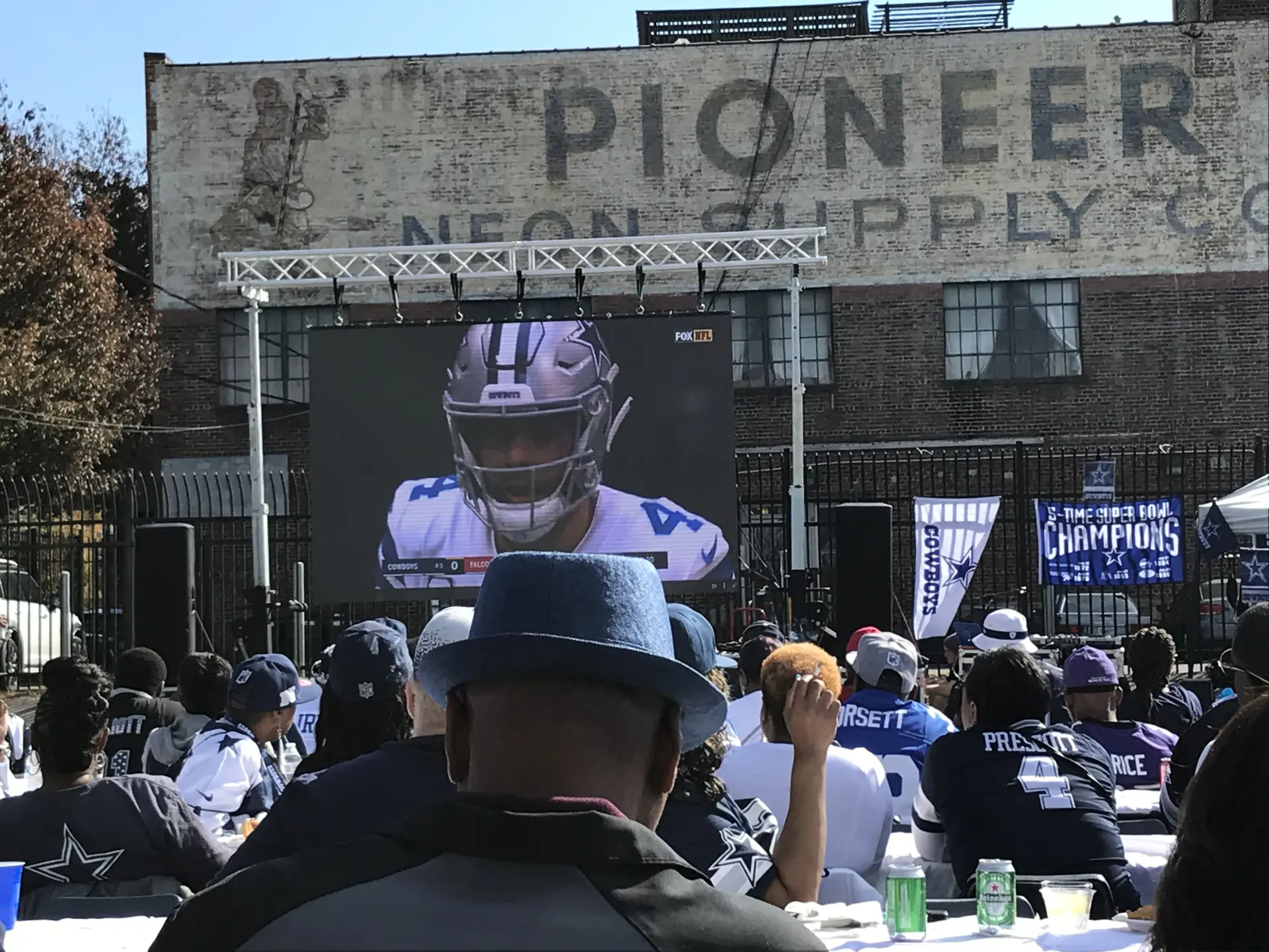 Outdoor LED video wall broadcasting live football at fan watch party