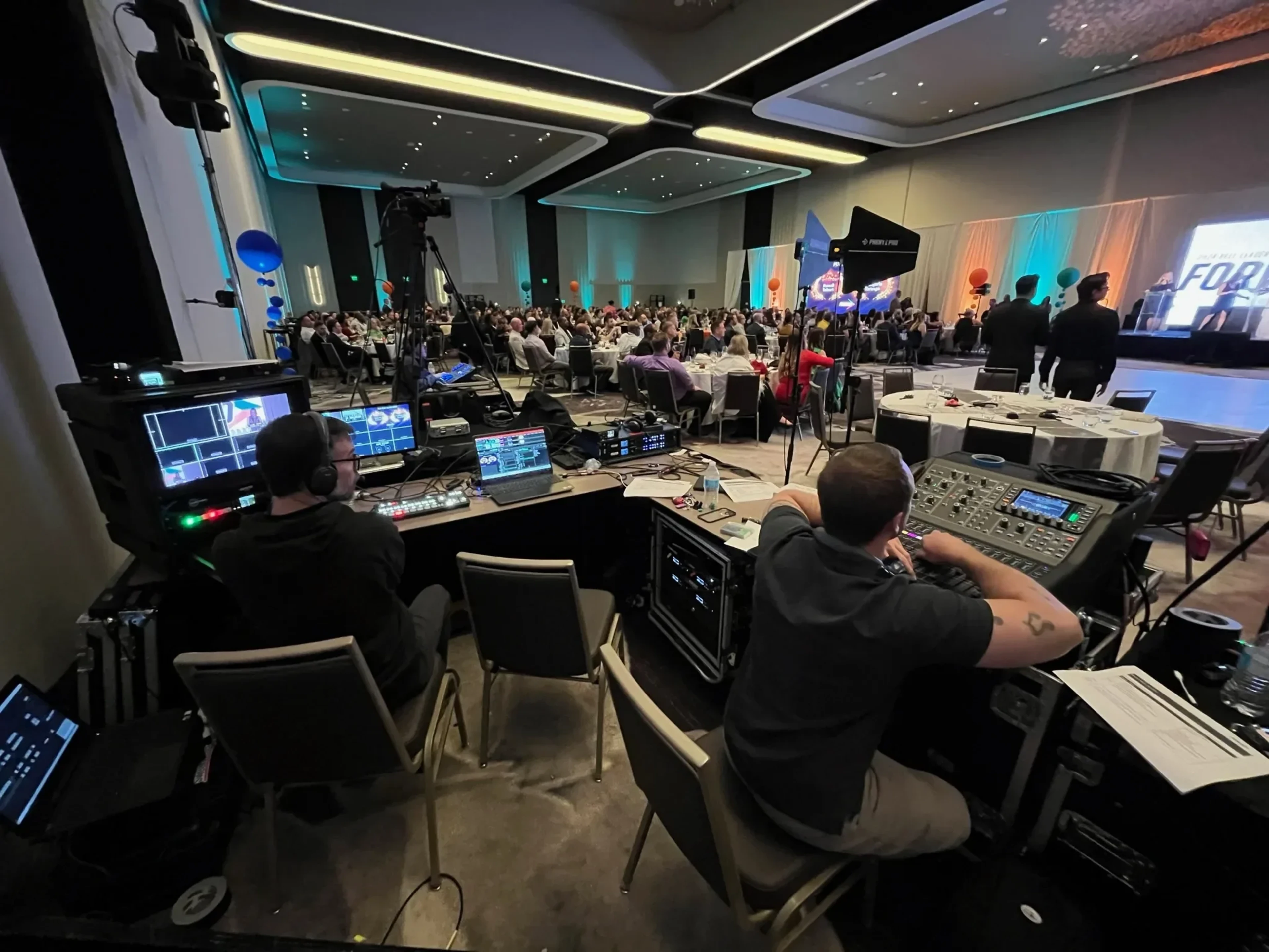 Production team coordinating backstage during an event