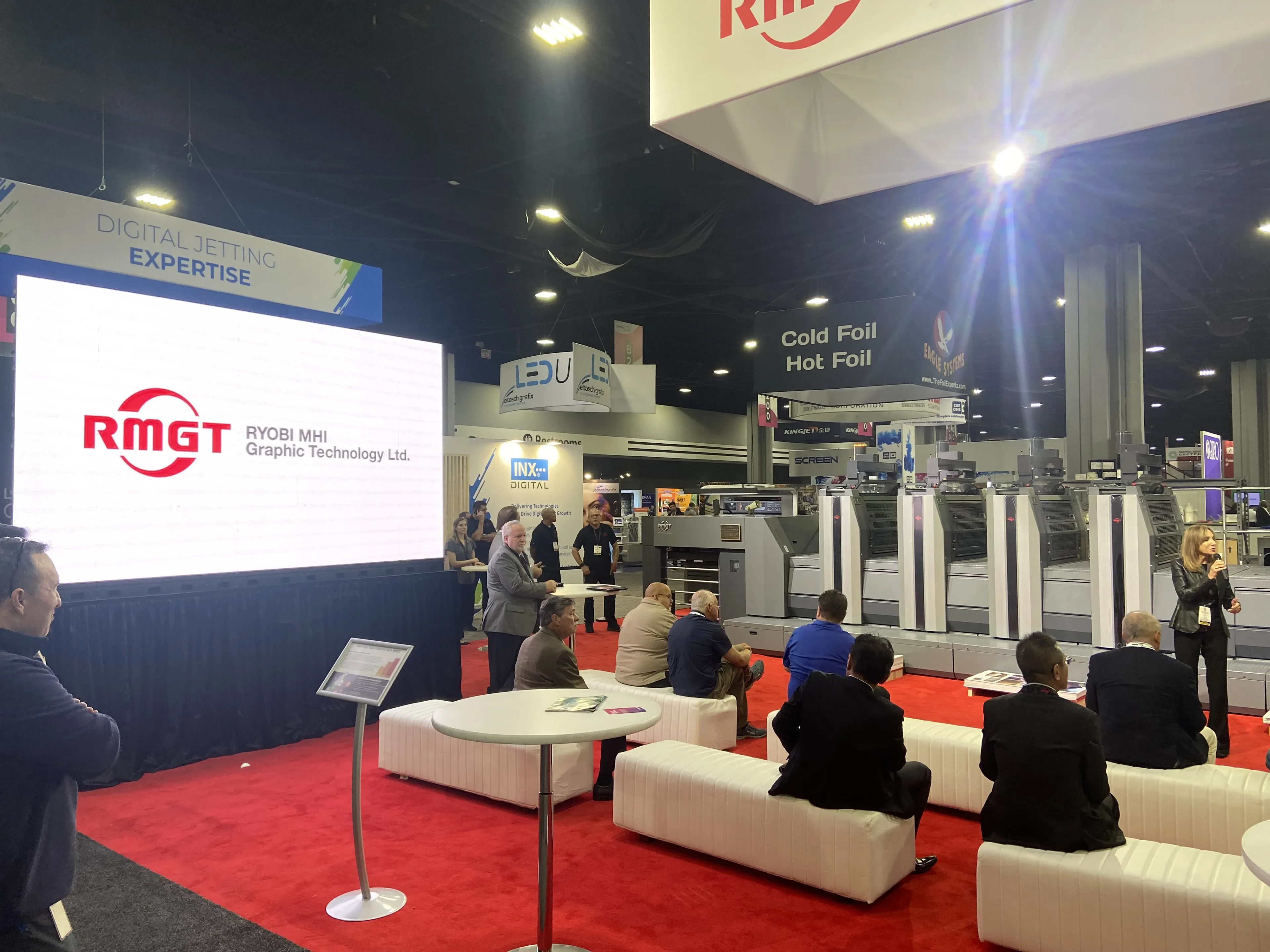 RMGT trade show booth with a large-format LED video wall