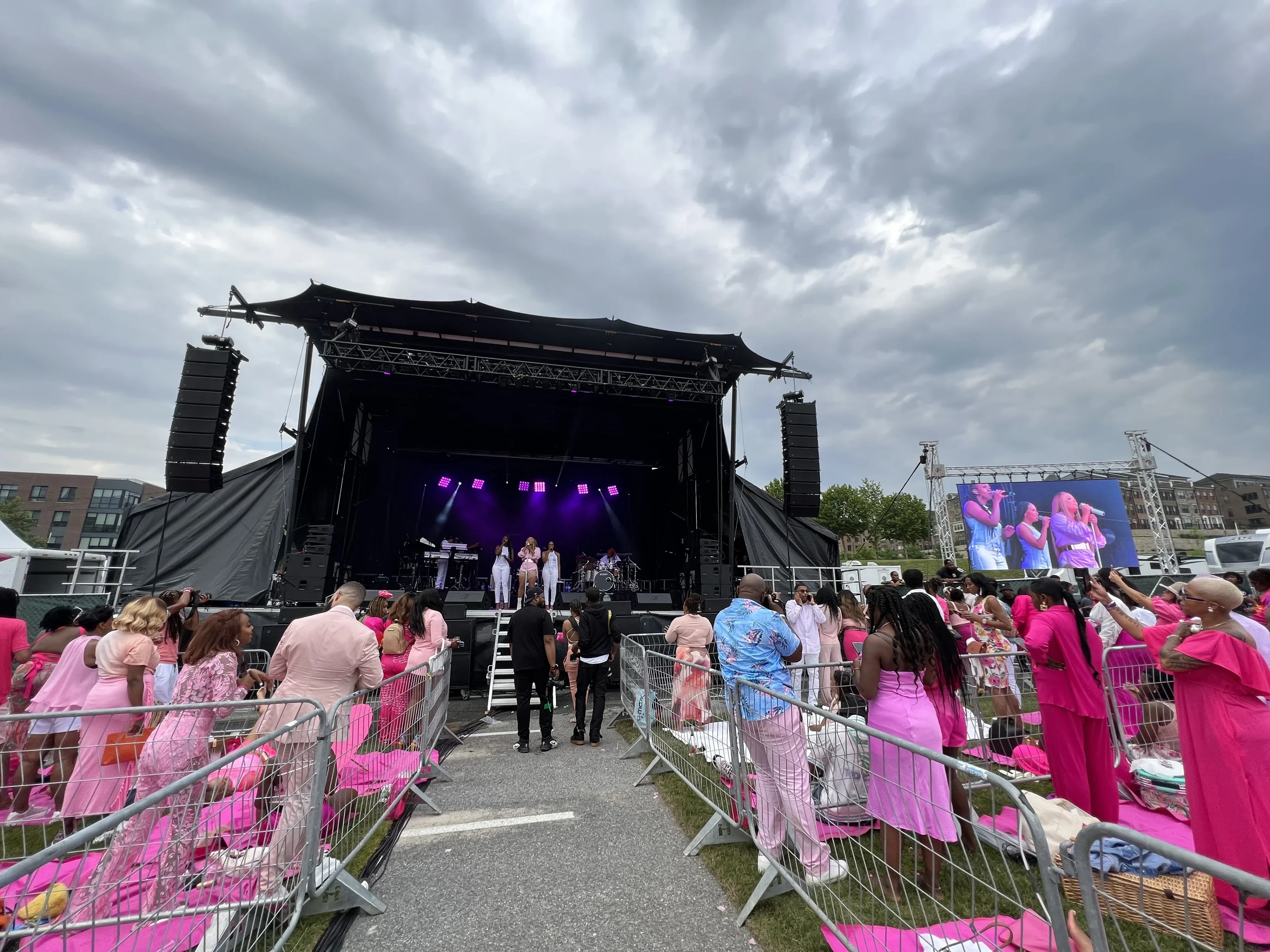 Outdoor festival stage with concert lighting at Celebrez En Rose Tour