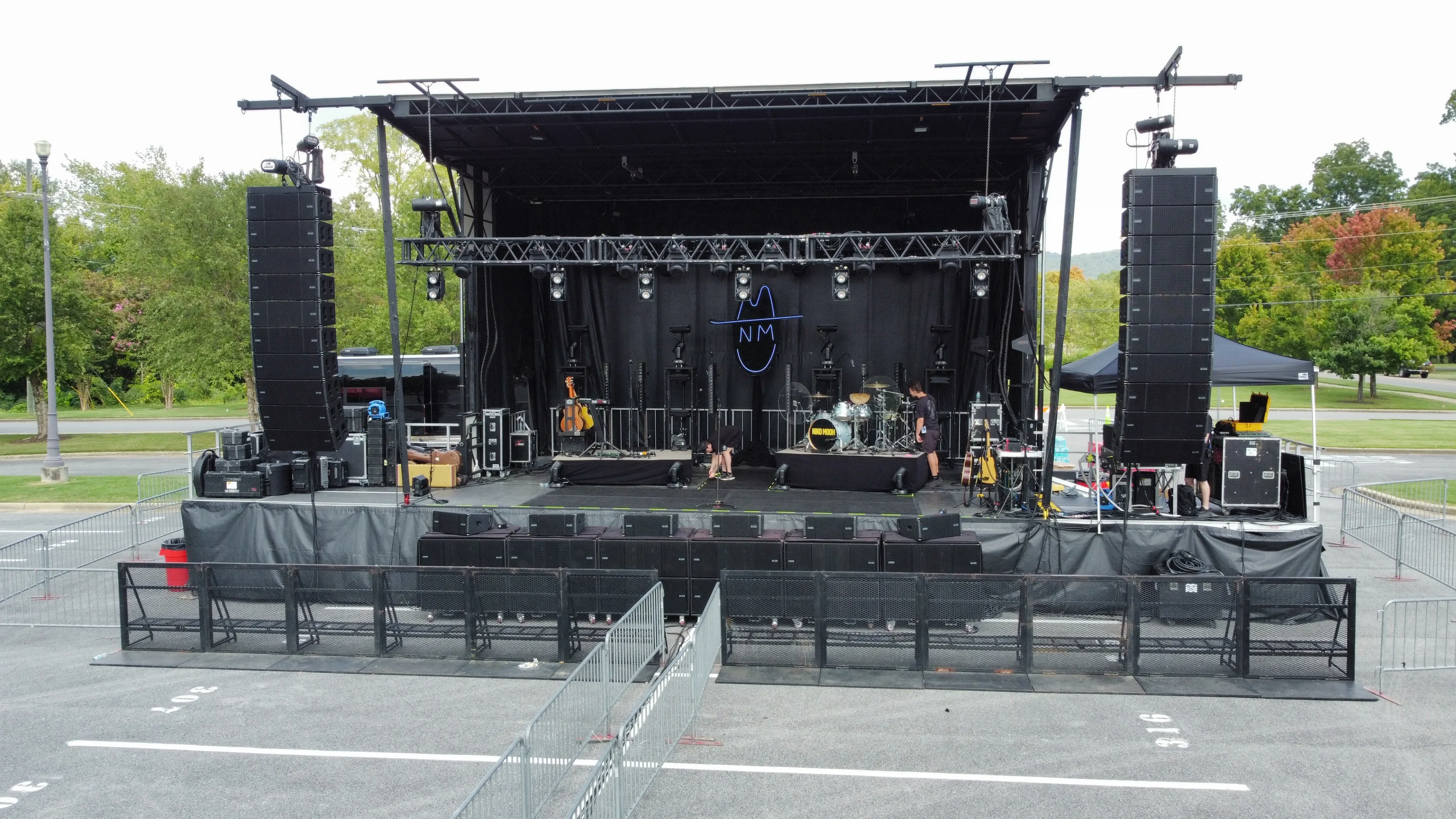 Flown line array PA system at outdoor festival with crowd