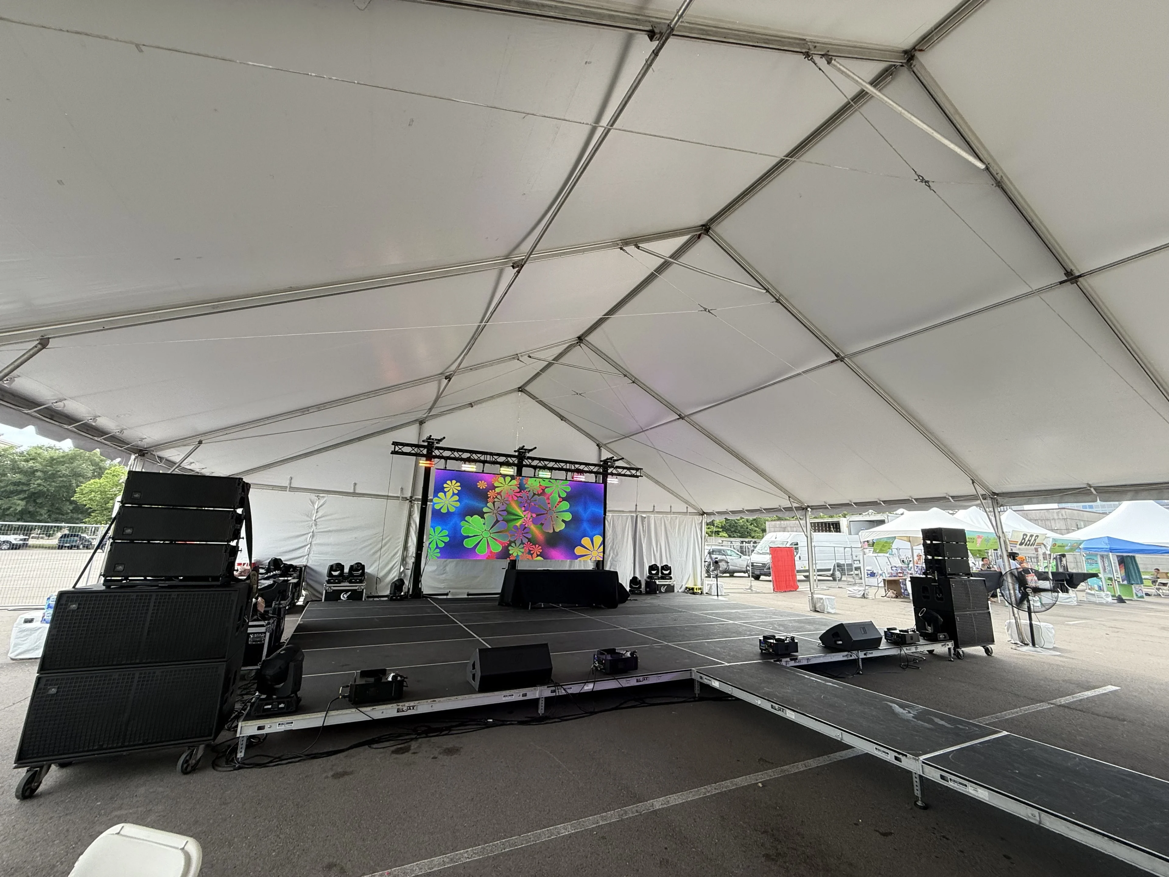 Outdoor festival with professional staging and weather contingency planning